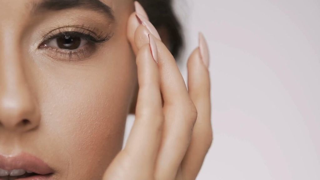 Woman touching her face showing smoothness from Botox treatment