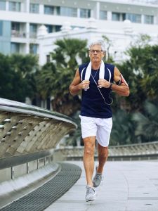 Senior-man-running Senior man running with ear buds in a city