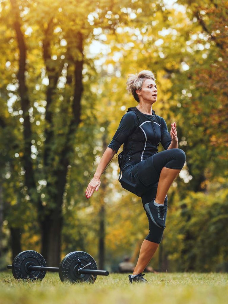 Middle aged, fit woman working out in a park