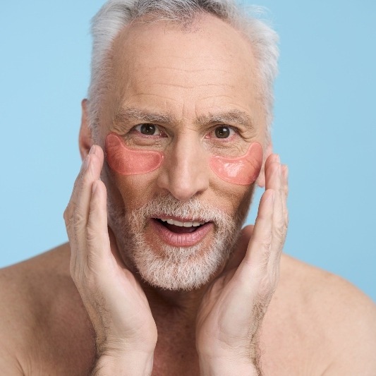 close-up-senior-man-with-anti-puffiness-and-anti-d-2025-02-20-09-06-09-utcmore