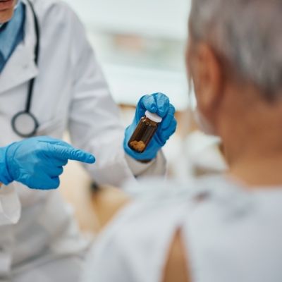 close-up-of-doctor-giving-medicine-to-mature-patie-2026-01-06-10-26-53-utcBF Close up of elderly patient receiving prescription medicine from doctor after medical examination in the hospital.