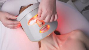 Woman with an LED mask on her face Woman with LED mask on her face